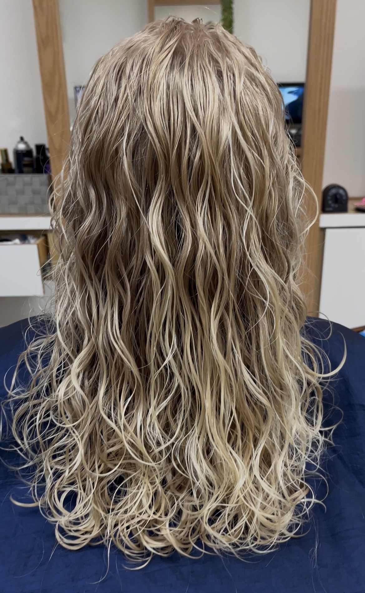 Before: warm, uneven blonde with grown-out roots during colour processing at Dass Hair Salon, Carrollton